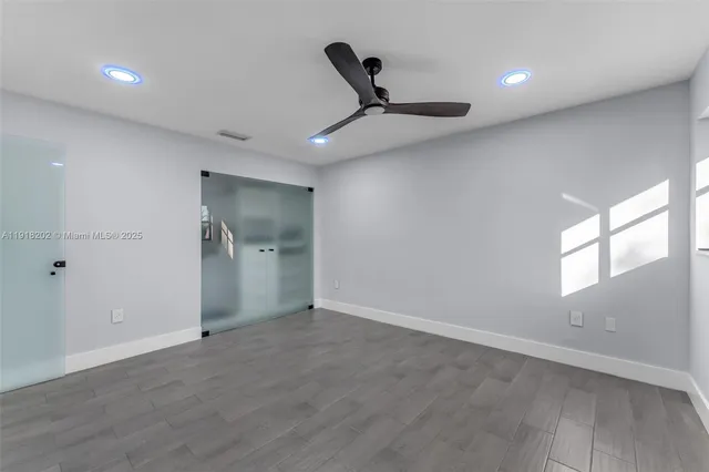 an empty room with windows and closet