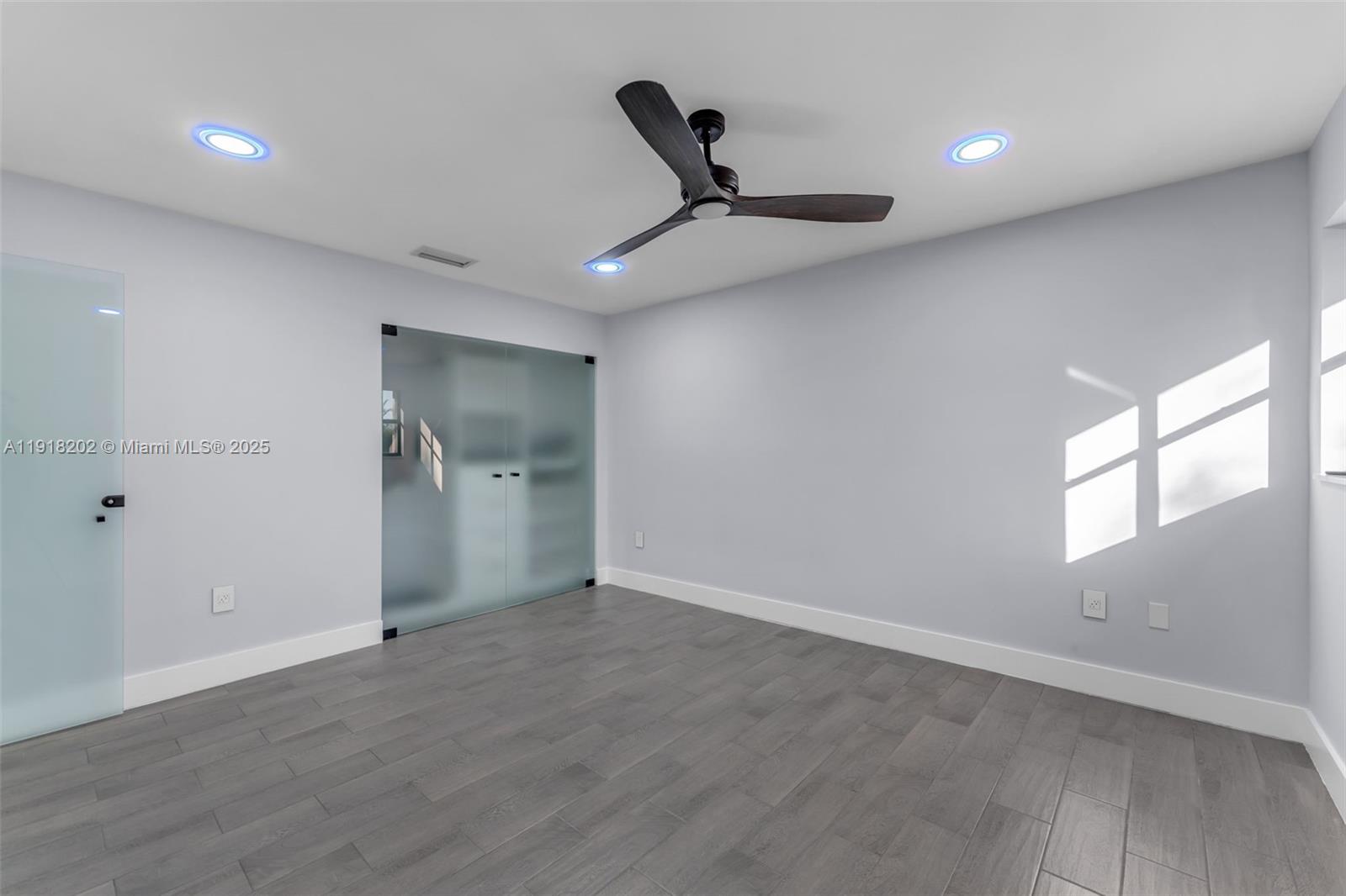 11830 Southwest 104th Lane Miami, FL 33186 - Photo 27 of 48 an empty room with windows and closet