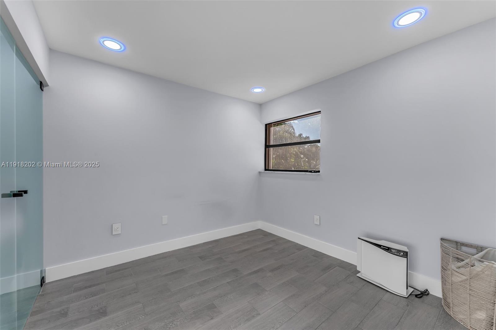 11830 Southwest 104th Lane Miami, FL 33186 - Photo 28 of 48 an empty room with wooden floor and windows