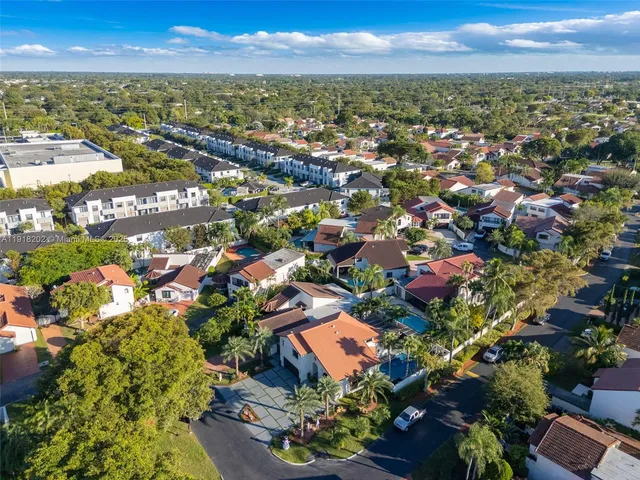 an aerial view of residential houses with outdoor space