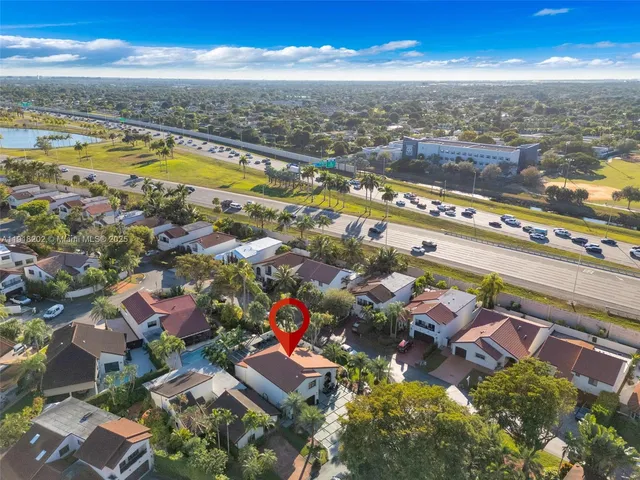 an aerial view of residential houses with outdoor space