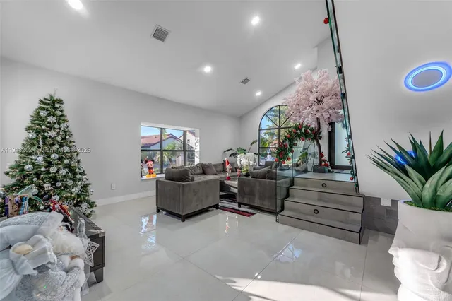 a living room with furniture and a christmas tree