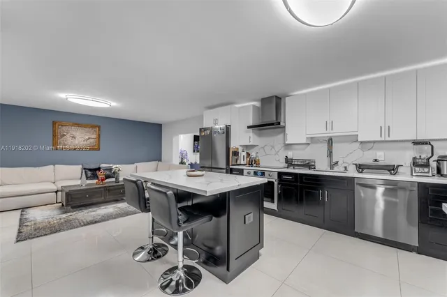 a kitchen with a stove a sink a dining table and chairs