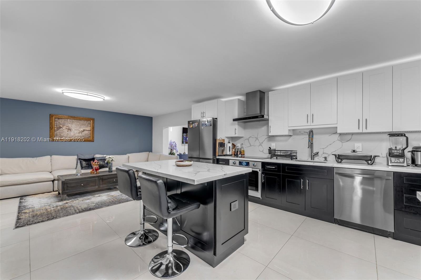 11830 Southwest 104th Lane Miami, FL 33186 - Photo 9 of 48 a kitchen with a stove a sink a dining table and chairs