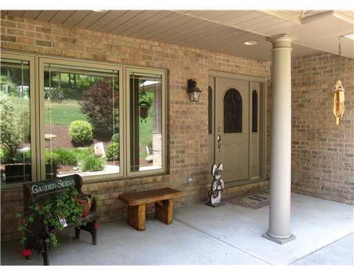 1299 Arona Road Irwin, PA 15642 - Photo 18 of 18 Exterior Front. Close up view of front entry. Picture perfect and window reflection shows the meticulously landscaped lot. WOW. Perfect!!