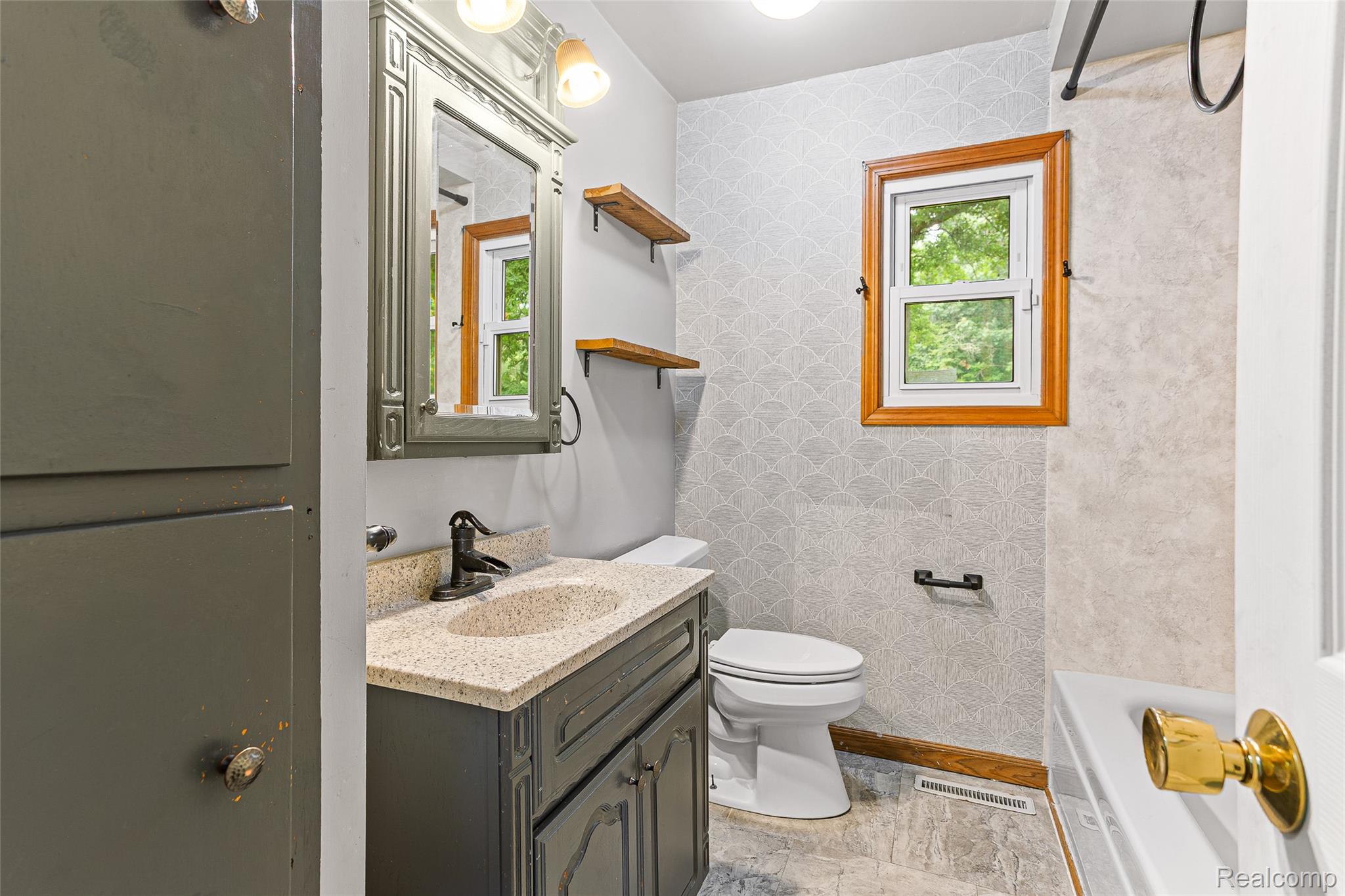 9561 Exeter Road Carleton, MI 48117 - Photo 30 of 46 Vanity with a speckled countertop, matte black faucet, and decorative mirror