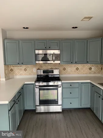 a kitchen with a stove oven and sink