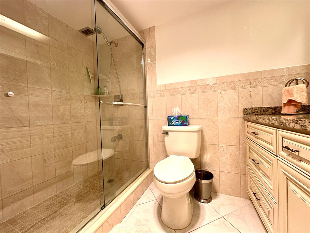 2671 South Course Drive, Unit 802 Pompano Beach, FL 33069 - Photo 12 of 34 a bathroom with a toilet and a shower