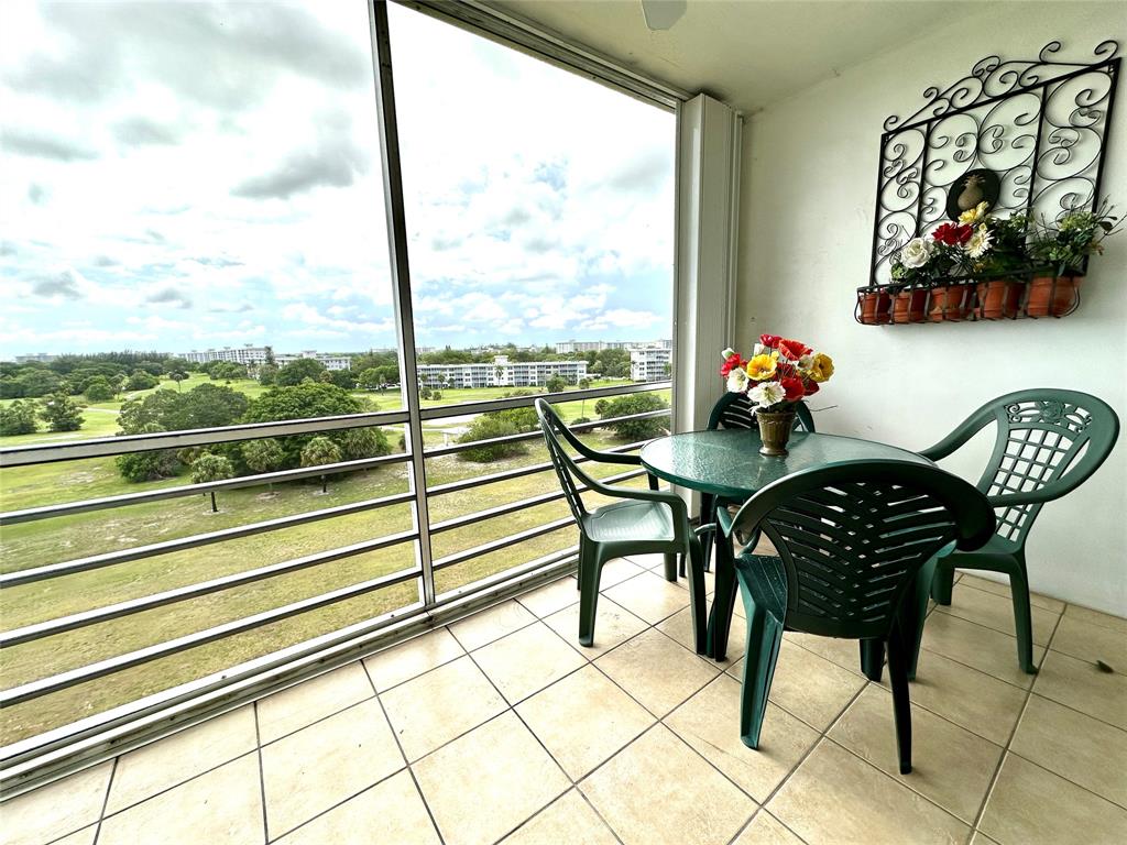 2671 South Course Drive, Unit 802 Pompano Beach, FL 33069 - Photo 17 of 34 a view of a chairs and table in the balcony