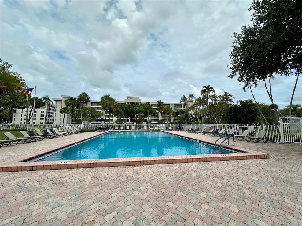 2671 South Course Drive, Unit 802 Pompano Beach, FL 33069 - Photo 20 of 34 a view of a swimming pool with a yard