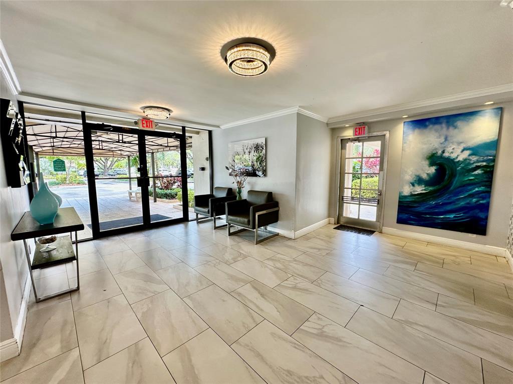 2671 South Course Drive, Unit 802 Pompano Beach, FL 33069 - Photo 29 of 34 a view of a livingroom with furniture and windows