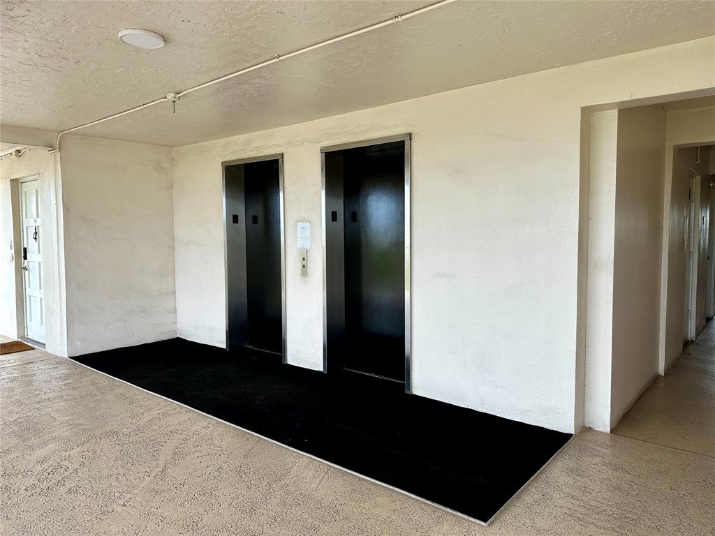 2671 South Course Drive, Unit 802 Pompano Beach, FL 33069 - Photo 30 of 34 a view of hallway with windows