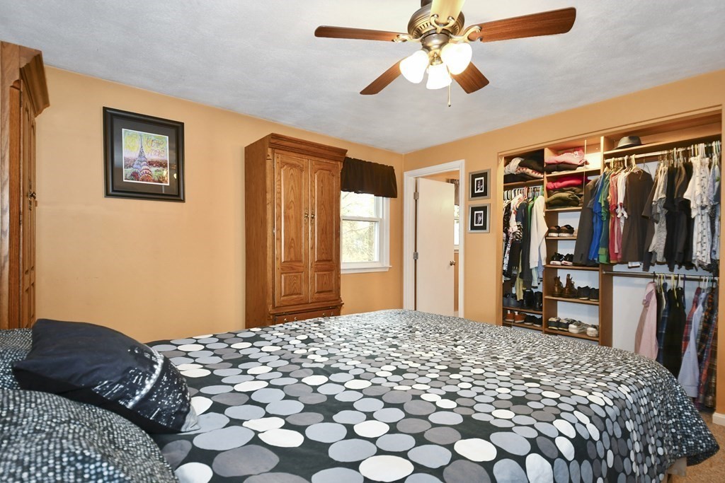 14 Oak Ridge Way Shrewsbury, MA 01545 - Photo 13 of 30 a bedroom with a large bed and a chandelier