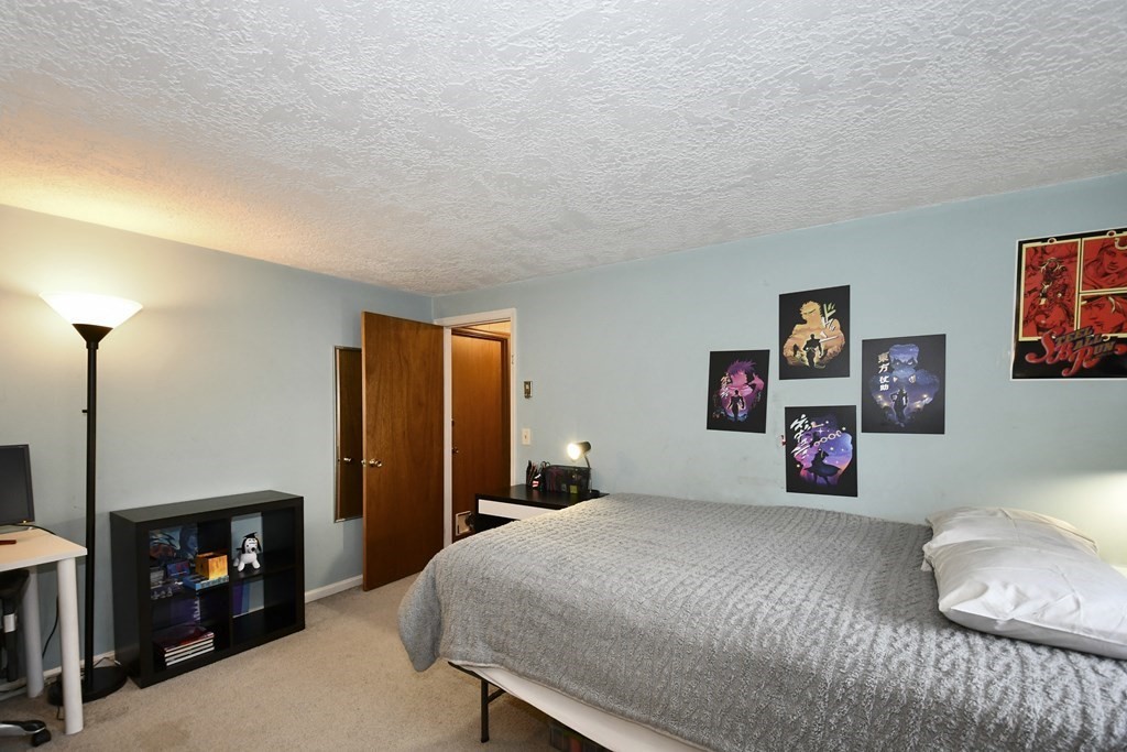 14 Oak Ridge Way Shrewsbury, MA 01545 - Photo 16 of 30 a bedroom with a bed and a fireplace