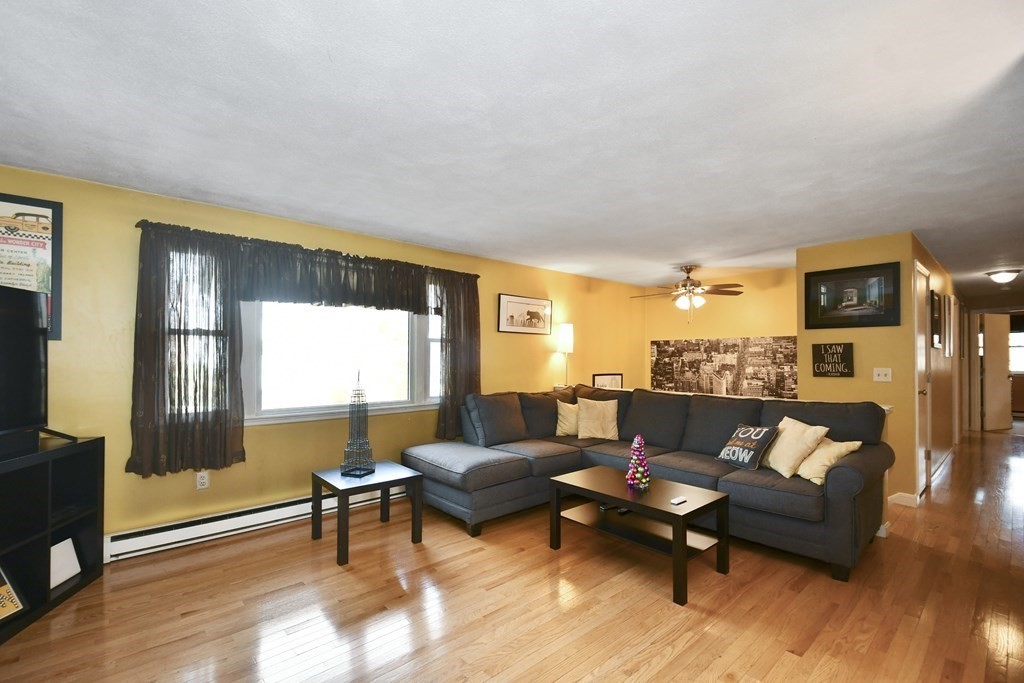 14 Oak Ridge Way Shrewsbury, MA 01545 - Photo 2 of 30 a living room with furniture and a wooden floor