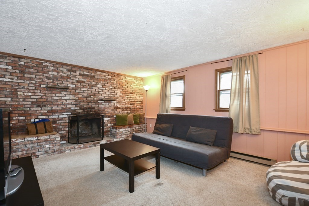 14 Oak Ridge Way Shrewsbury, MA 01545 - Photo 21 of 30 a living room with furniture and a fireplace