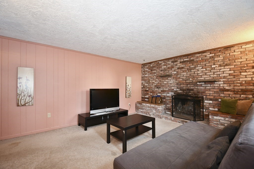 14 Oak Ridge Way Shrewsbury, MA 01545 - Photo 23 of 30 a living room with furniture and a fireplace