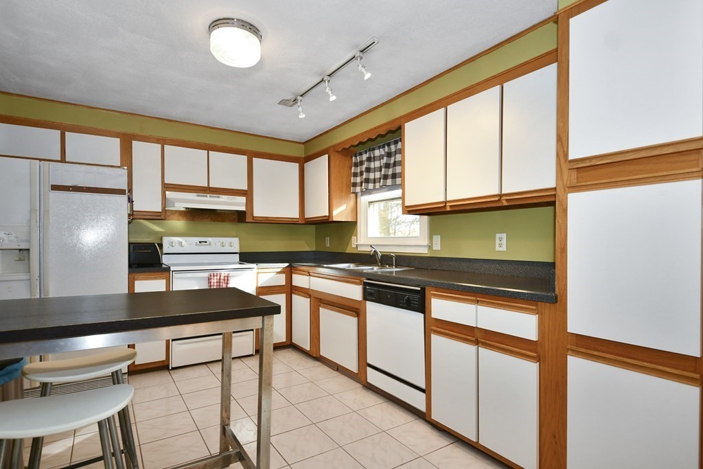 14 Oak Ridge Way Shrewsbury, MA 01545 - Photo 7 of 30 a kitchen with stainless steel appliances granite countertop a stove a sink and a refrigerator