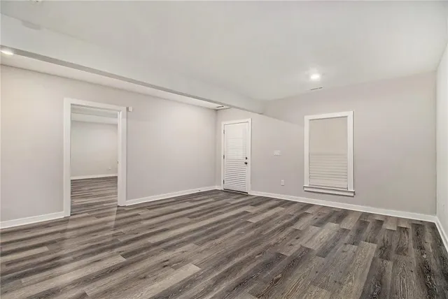a view of an empty room and wooden floor