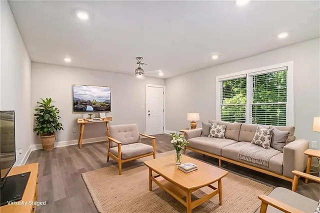 a living room with furniture and a large window