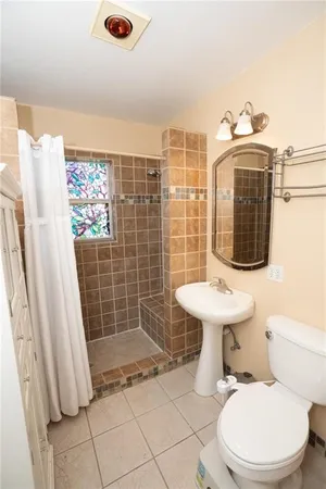 a bathroom with a toilet sink and shower