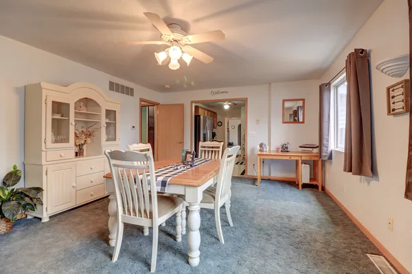 a view of a dining room with furniture and chandelier
