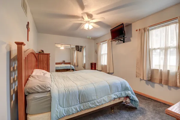 a bed room with a bed and a chandelier