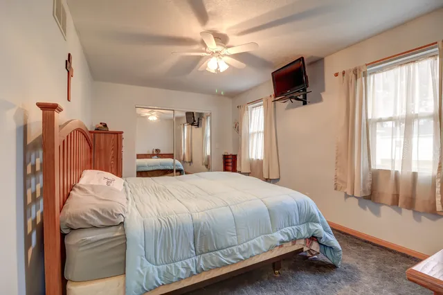 a bed room with a bed and a chandelier