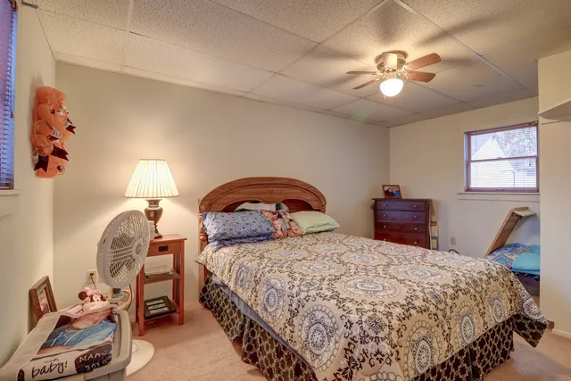 a bedroom with a bed and a chandelier