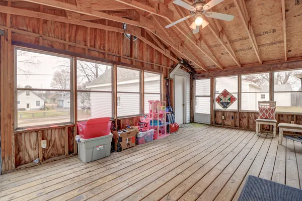 a view of a room with wooden floor and furniture
