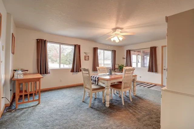 a dining room with furniture and window