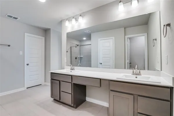 a bathroom with a sink double vanity and a mirror