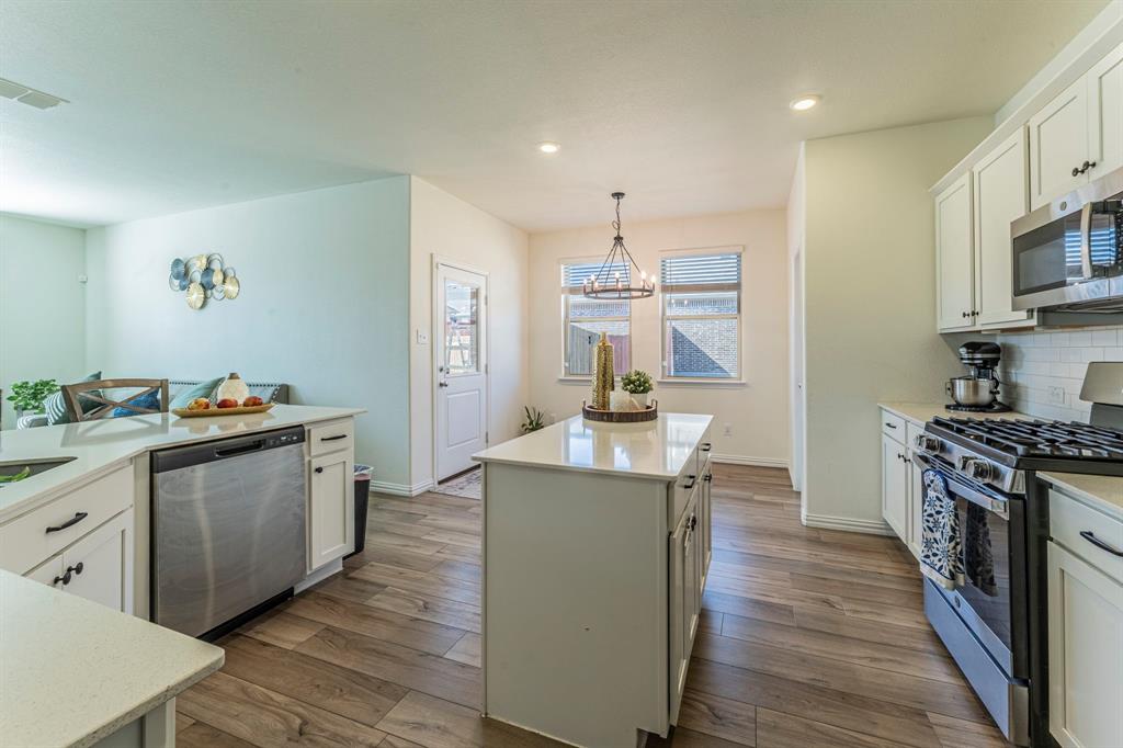 1240 Almond Road Azle, TX 76020 - Photo 4 of 26 a kitchen with stainless steel appliances granite countertop a stove and a sink
