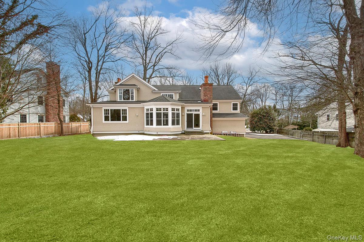8 Walden Lane Rye, NY 10580 - Photo 23 of 28 Rear view of property with a patio area off the family room, and a fenced backyard