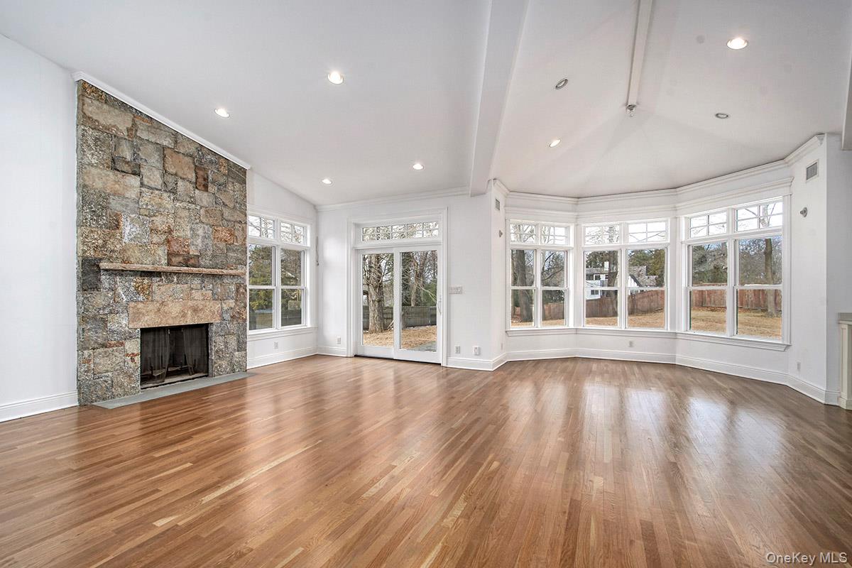 8 Walden Lane Rye, NY 10580 - Photo 8 of 28 Light filled Family Room with hardwood floors and rustic stone fireplace
