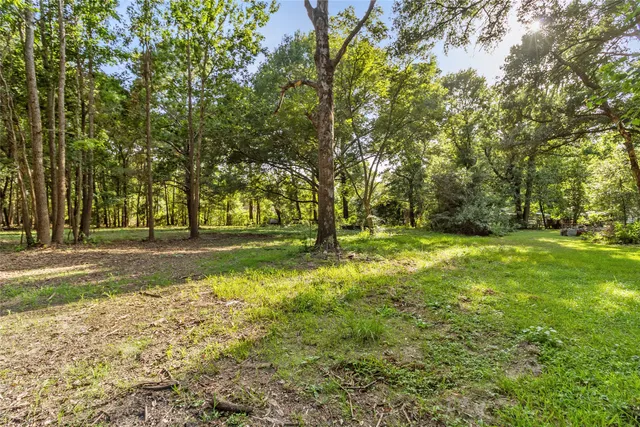 an aerial view of a house with yard