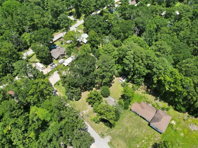 an aerial view of a house with yard