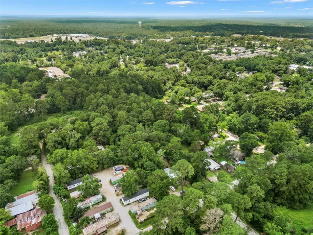 a view of a backyard with large trees