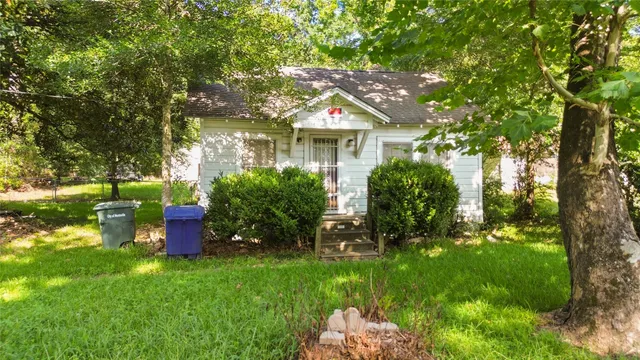 a backyard of a house with table and chairs