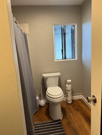 a bathroom with a toilet and a shower curtain