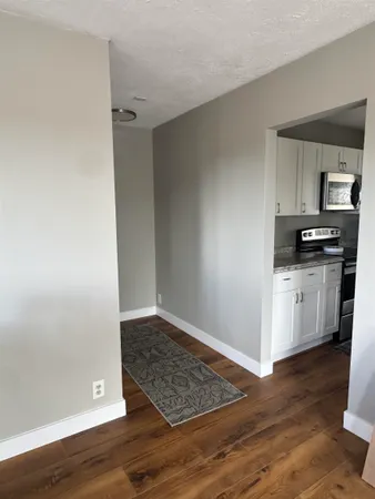 a view of kitchen with wooden floor electronic appliances and window