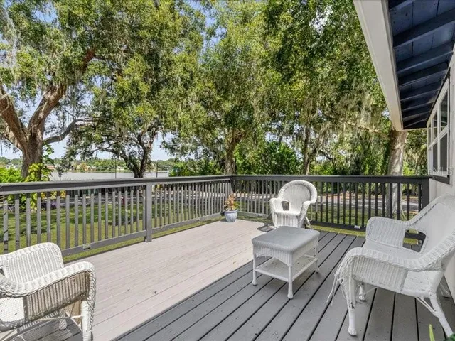 a view of a chair and table on the deck
