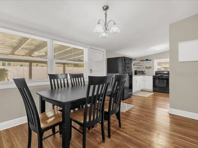 a view of a dining room with furniture window and wooden floor