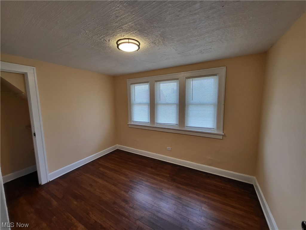 955 Nela View Road Cleveland Heights, OH 44112 - Photo 10 of 34 Unfurnished room with a textured ceiling and dark hardwood / wood-style floors