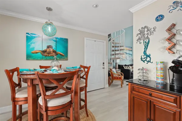 a dining room dining table chairs and a chandelier