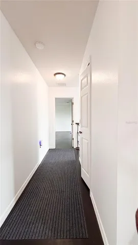 a view of a bedroom with wooden floor