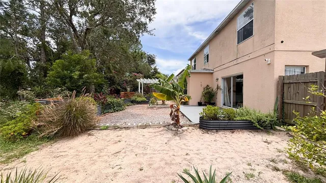 a view of a house with backyard and sitting area