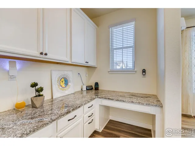 a kitchen with granite countertop a sink a stove and cabinets