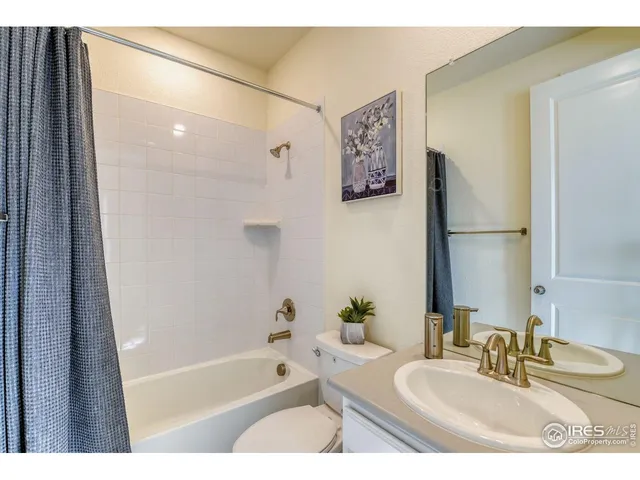 a bathroom with a tub a sink and a mirror