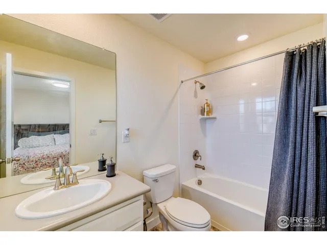 a bathroom with a sink toilet vanity and shower